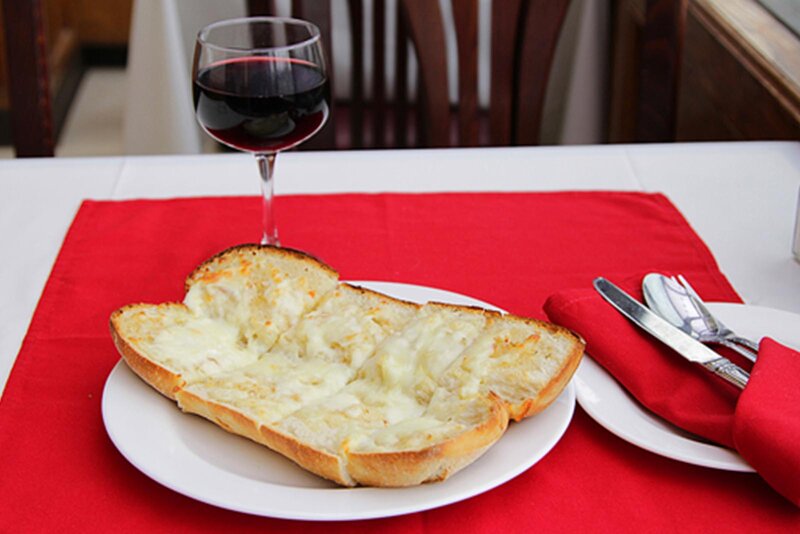 Garlic bread with a glass of red wine